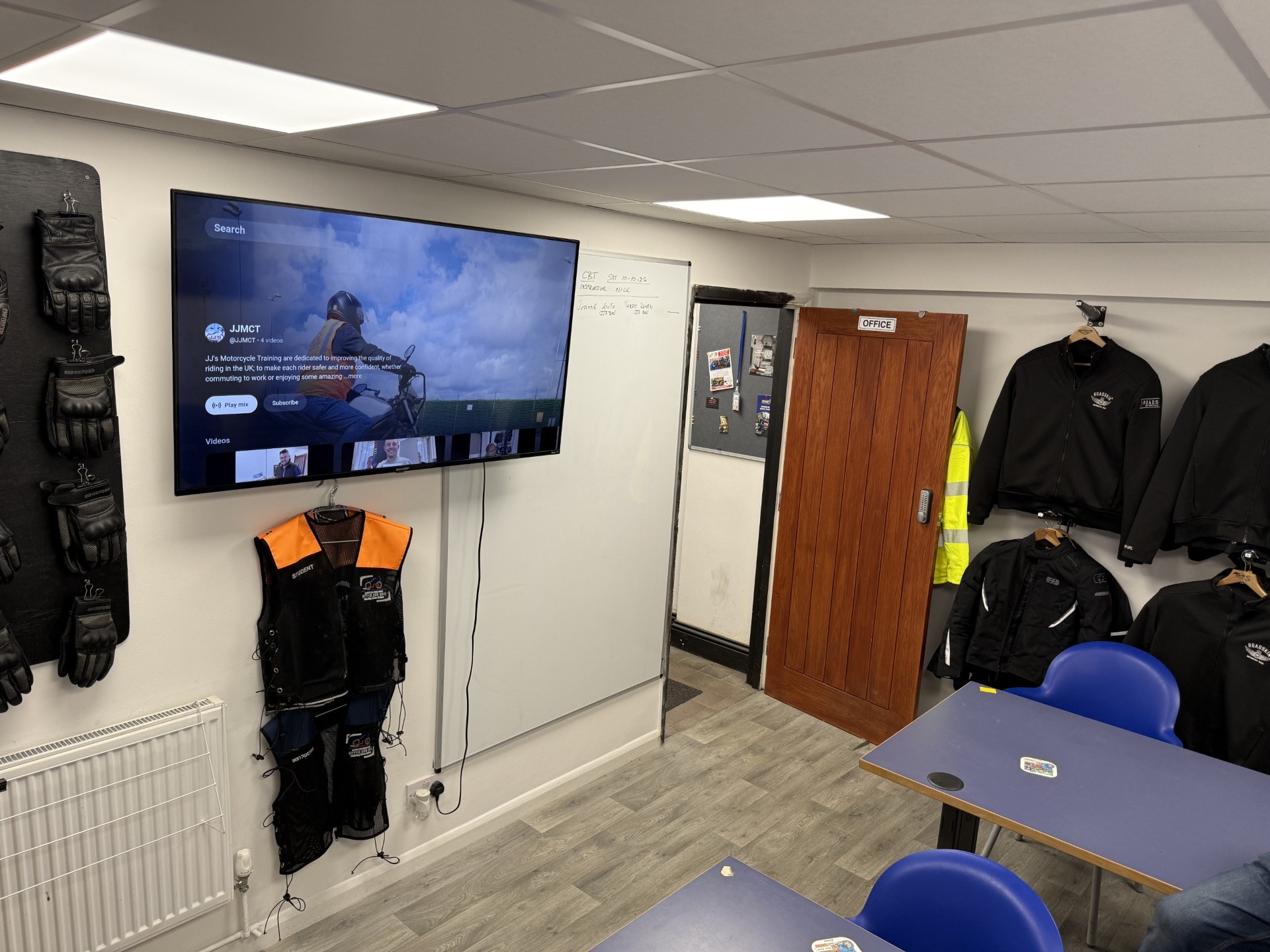 JJ's classroom with gear displays and TV
