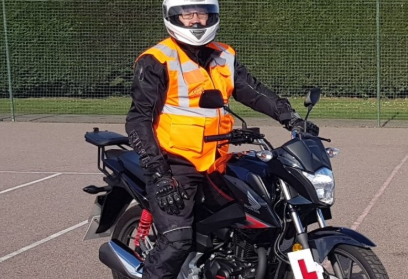 Student on motorcycle with L plate and hi-vis