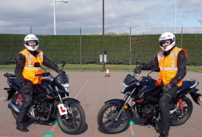 Two students on motorcycles with L plates